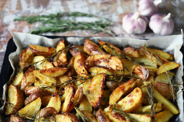 istock Delicious rustic baked potato with rosemary and garlic. 1296180017