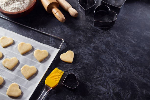 istock Making of Heart Shaped Cookies on Kitchen Table 1296183967