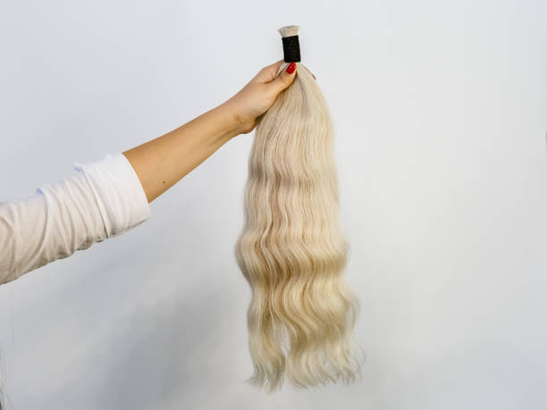 istock Bundle of blonde natural human hair extensions 1296185244