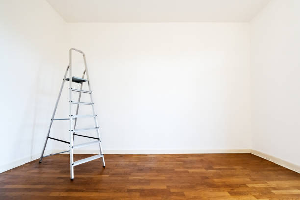 Metal ladder and building materials in hall prepared for renovation