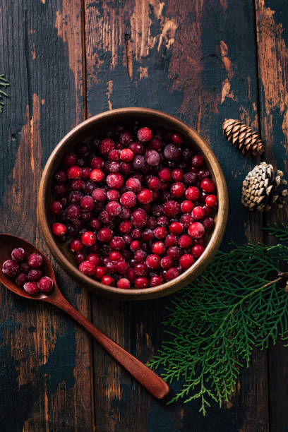 istock Cranberries in a plate on a wooden background. Copy space 1296186764