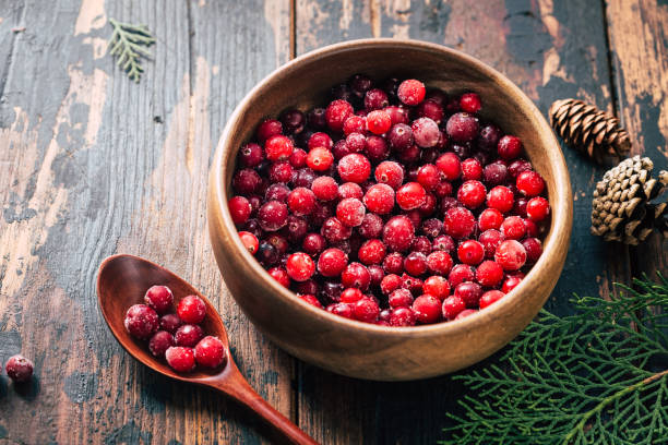 istock Cranberries in a plate on a wooden background. Copy space 1296187537