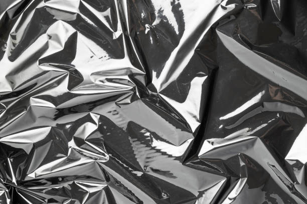 istock Plastic texture background. Wrap transparent dark cellophane. Cellophane black shiny film bag pattern. Creative crumpled background. 1296189143