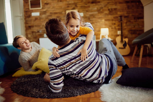 istock Carefree father and daughter having fun while playing at home. 1296192141