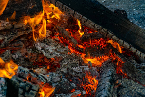 Burning coals at night, rotting coal, barbecue season. Close-up.