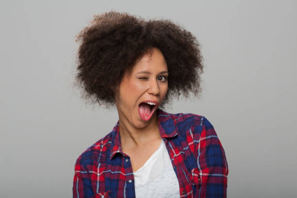 istock Young woman winking eye 1296194060