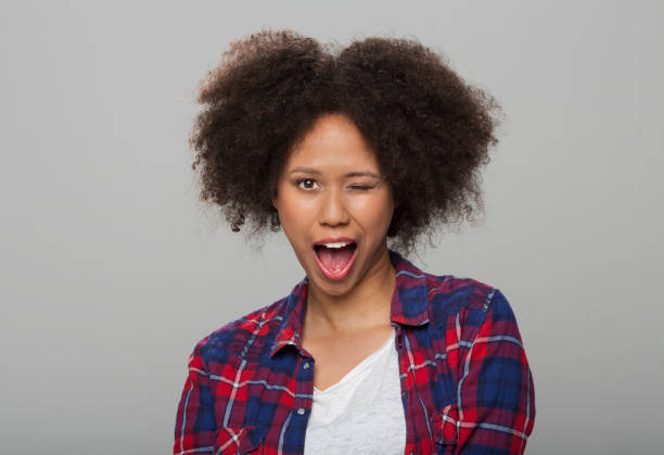 istock Young woman winking eye 1296194083