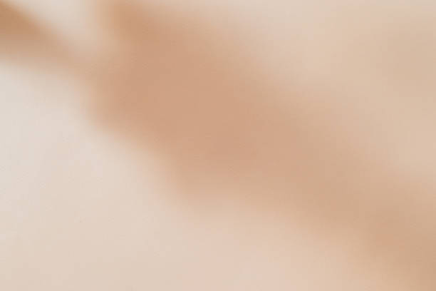 istock Abstract shadow blurred background on sand color background. Natural light effects 1296194117