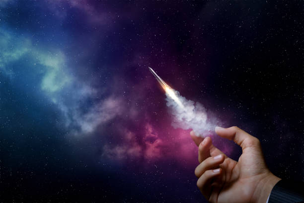 Startup concept and promotion. Startup concept and promotion. Hand launches a rocket on the background of outer space. model rocket stock pictures, royalty-free photos & images