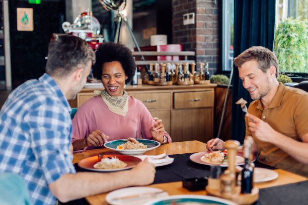 istock Colleagues enjoying business lunch at the restaurant 1296195662