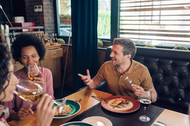 istock Group of colleagues having a business lunch after work 1296195685