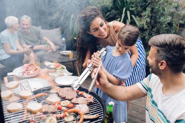 istock Happy family making barbecue in the backyard 1296196456