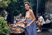 Portrait of a happy woman making barbecue