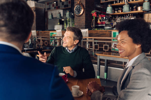 istock Business partners collaborating at the cafe 1296196532