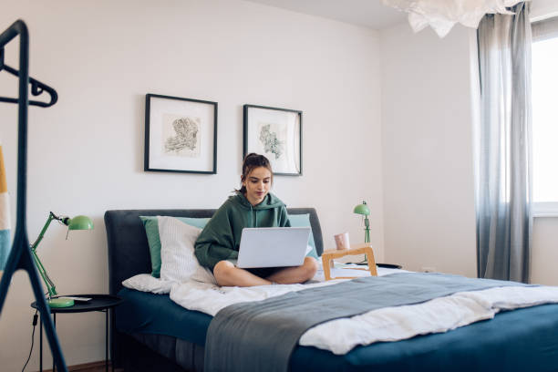 istock Girl learning online in her bed 1296197019