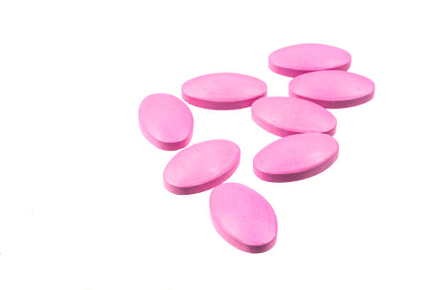 istock pink pills on a white isolated background 1296198296