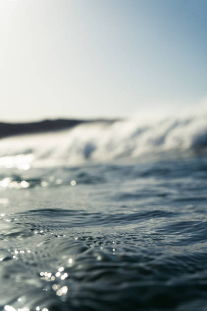 istock Breaking Waves and spray, white water and light reflected on the surface of the water 1296198553
