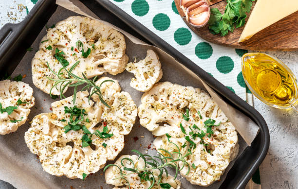 istock Cooking baked cauliflower steaks. 1296198653