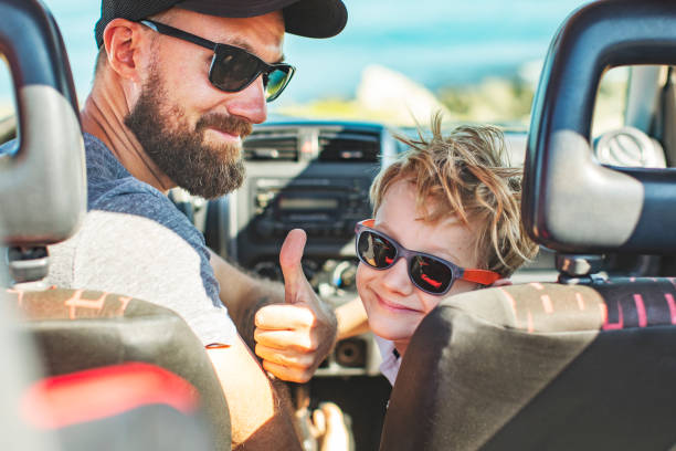 istock Road trip. Father and son travelling together by car 1296199654