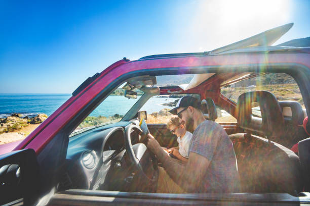 istock Road trip. Father and son travelling together by car 1296199658