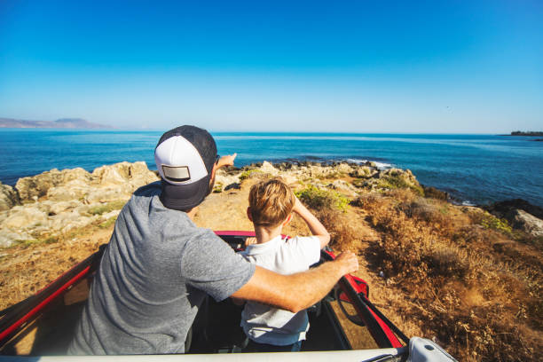 istock Road trip. Father and son travelling together by car 1296199680