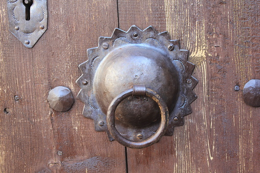 Karabuk, Turkey-February 5, 2011: A metal knob on a brown wooden door in Safranbolu.