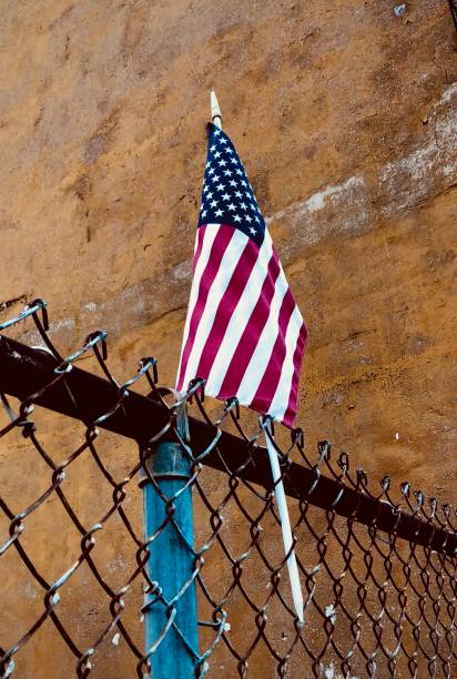 istock Small American Flag on Fence 1296200104
