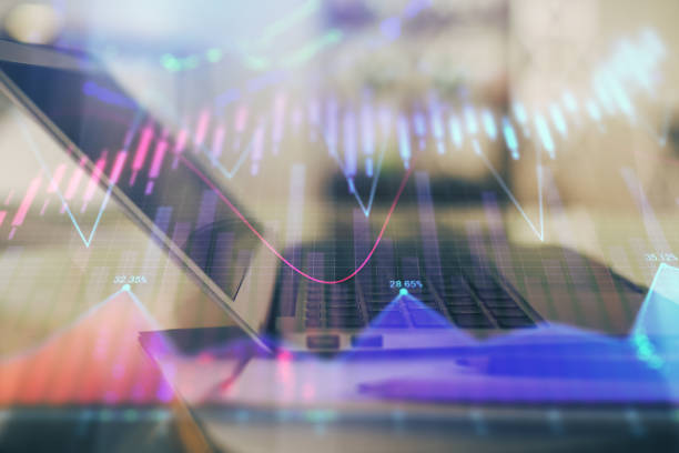 istock Forex graph hologram on table with computer background. Double exposure. Concept of financial markets. 1296201086