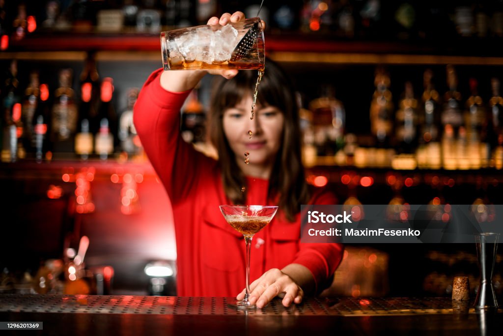 https://media.istockphoto.com/id/1296201369/photo/front-view-on-wineglass-standing-on-bar-and-bartender-holding-mixing-cup-and-accurate-pours.jpg?s=1024x1024&w=is&k=20&c=DM2QT5rRXm7ukyV9rSrN08IEkla_zvLD_Gu0C97CRYk=