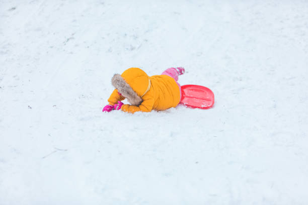 istock little girl playing outdoors in snow 1296202196
