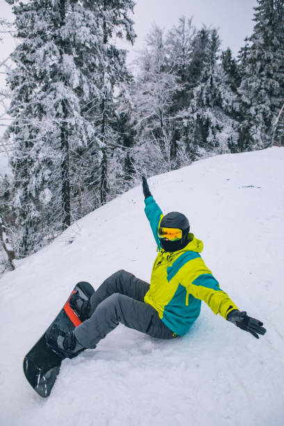 istock man strap in snowboard. winter sport activities 1296203465