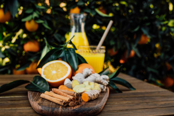 istock Cinnamon sticks with freshly squeezed orange juice of untreated Bio oranges and sliced ginger and fresh turmeric in the background 1296203657
