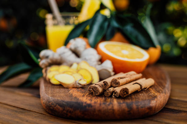 istock Cinnamon sticks with freshly squeezed orange juice of untreated Bio oranges and sliced ginger in the background 1296204095