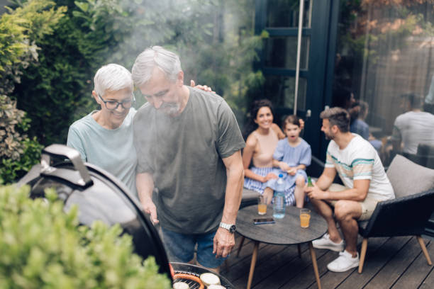 istock Senior couple making BBQ for their family 1296208126