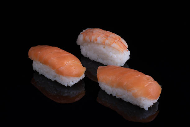 istock classic sushi with salmon isolated on black with reflection 1296208407