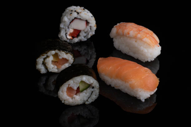 istock classic sushi with salmon isolated on black with reflection 1296208421
