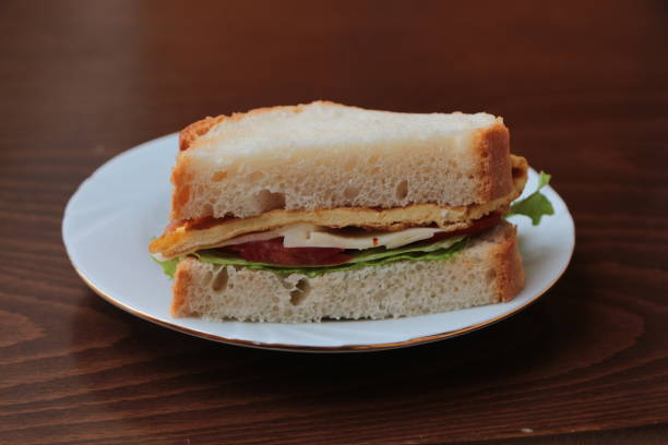 istock Sandwich with omelette (eggs). Fast, tasty, hearty and nutritious breakfast. 1296209299