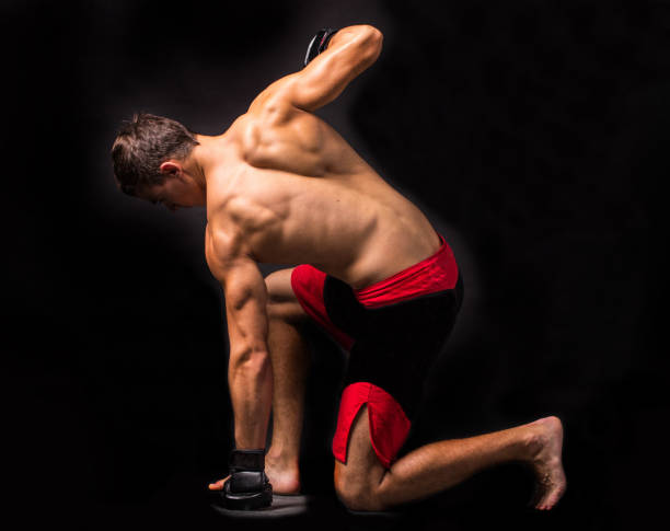 istock Portrait of boxer posing in studio in gloves. 1296209303