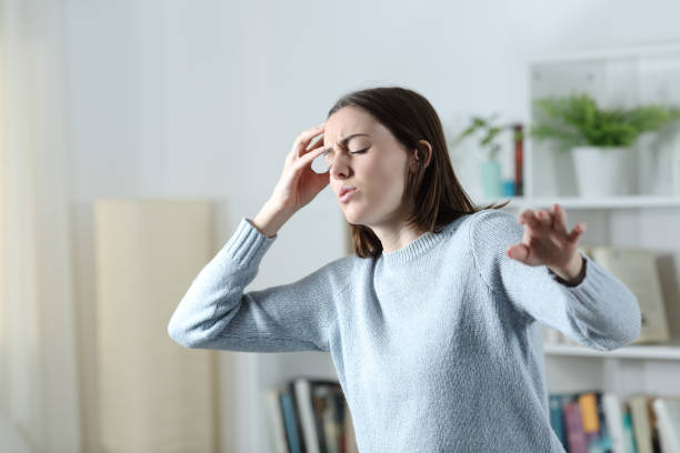 istock Dizzy woman suffering vertigo attack at home 1296209723