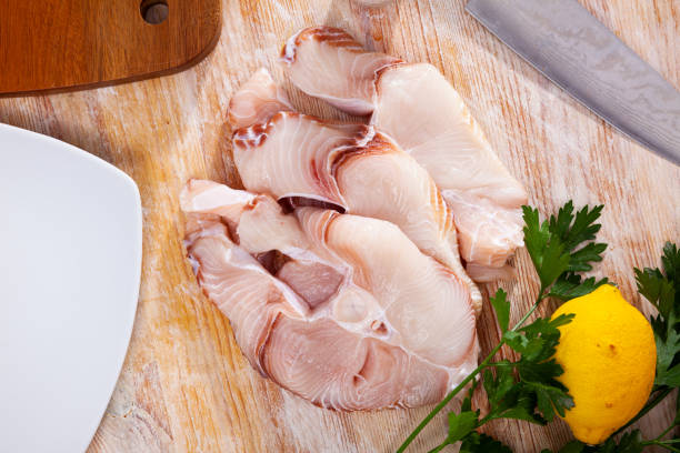 istock Tiger shark fillet on cutting board with lemon and parsley 1296211818