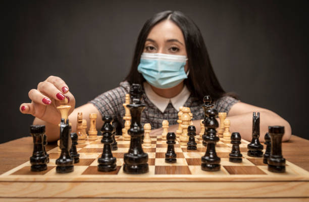 istock Elegant Couple playing chess. 1296214132