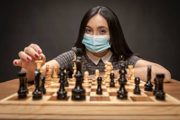 istock Elegant Couple playing chess. 1296214140