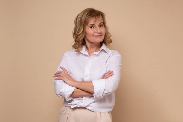 istock Smiling mature woman looking confident at camera. Studio shot. 1296215387