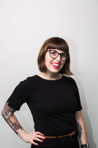istock Hipster Nerdy Young Woman Smiling Studio Portrait 1296215673