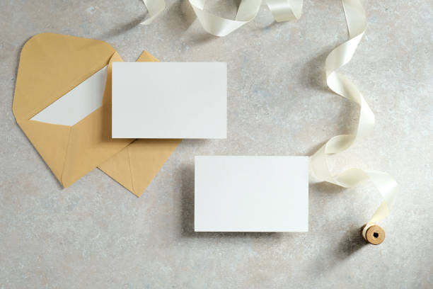 istock Wedding invitation cards and envelopes on concrete table. Flat lay, top view. Love, romance concept. 1296216570
