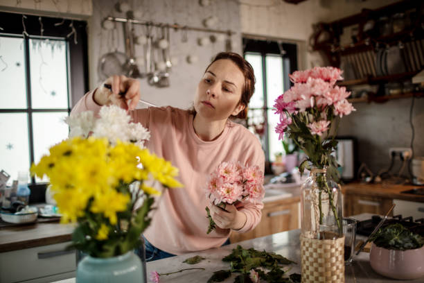 istock Arranging a flowers at home. 1296219564