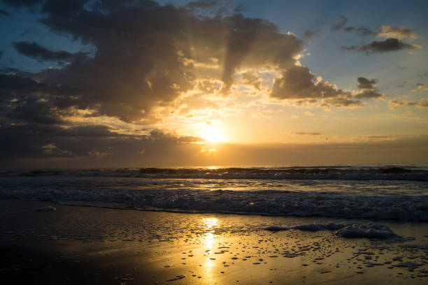 istock Beautiful Colorful Sunrise Over the Ocean with Clouds and Waves 1296220189
