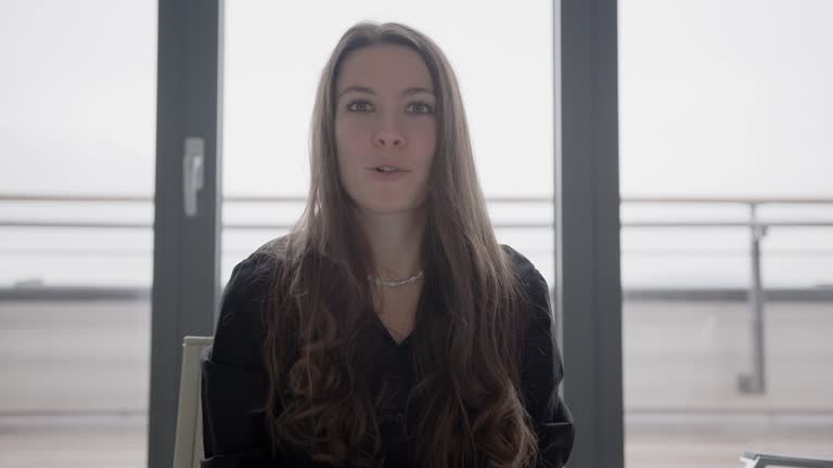 Caucasian woman talking and listening while looking at camera