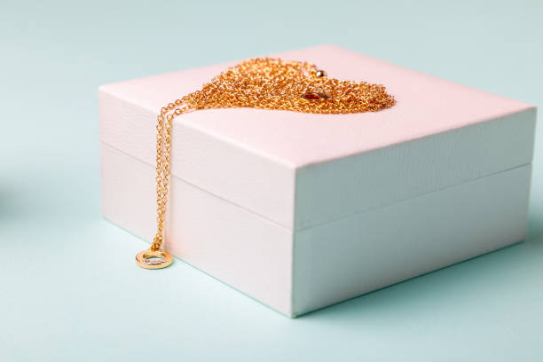 istock Valentine's Day. Perfume and a box with a chain on a blue background.. 1296223666