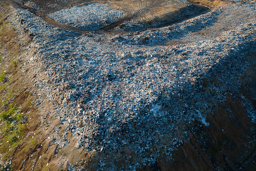 Waste disposal site or landfill with plastic and other inorganic waste harmful to nature, aerial view.